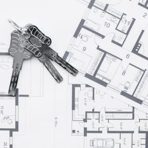 house-keys-on-architectural-blueprints-plans